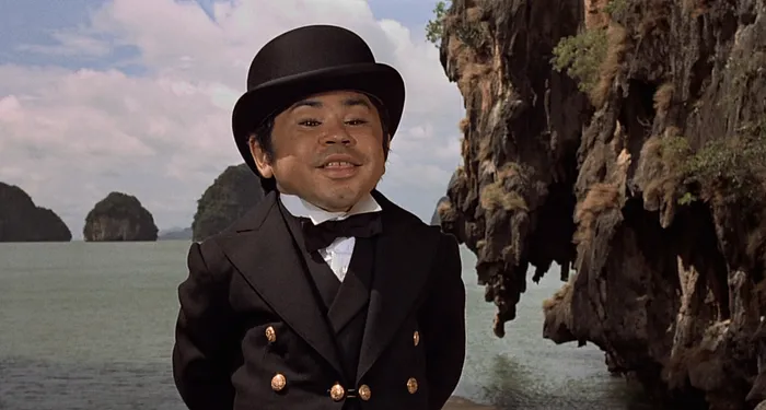 Hervé Villechaize as Nick Nack, dapper in a bowler hat and tuxedo on the Thai island lair in The Man with the Golden Gun