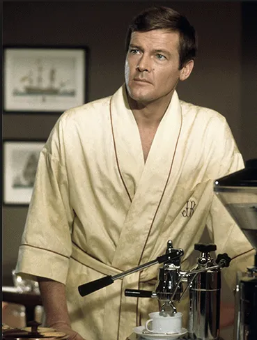 Roger Moore in a monogrammed robe, making espresso with studied nonchalance in Live and Let Die
