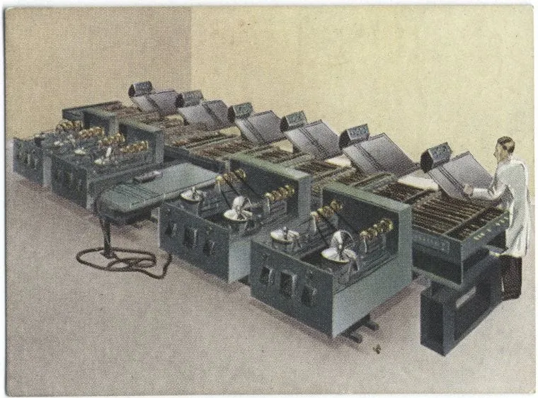 Vintage illustration of a room-sized early computer system with multiple cabinets containing tape reels and circuitry, and a technician standing at one end